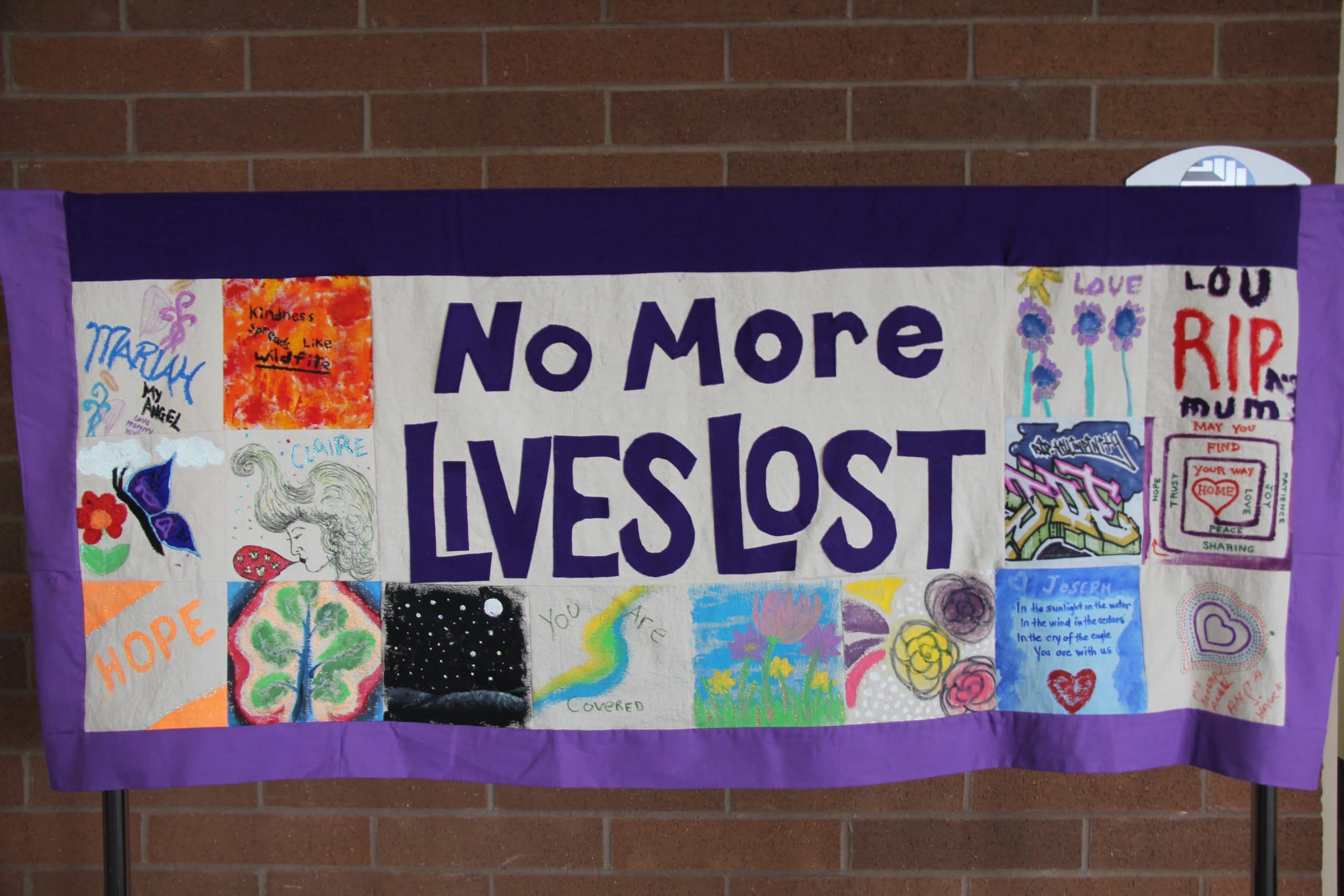 Quilted banner reading "no more lives lost"